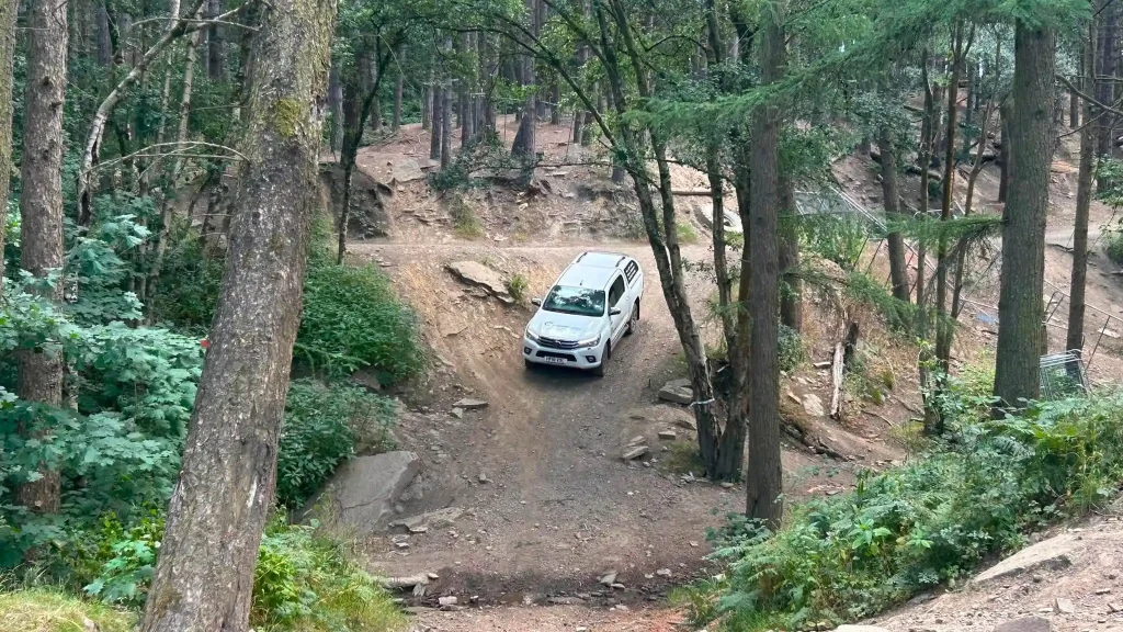 Lantra 4×4 operator training vehicle descending an uneven off-road slope near Bradford