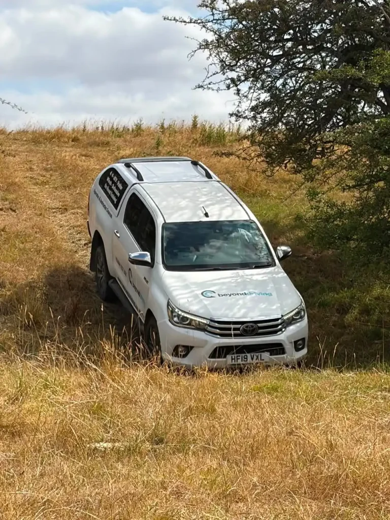 Toyota Hilux tackling steep uneven terrain during Lantra 4x4 operator training