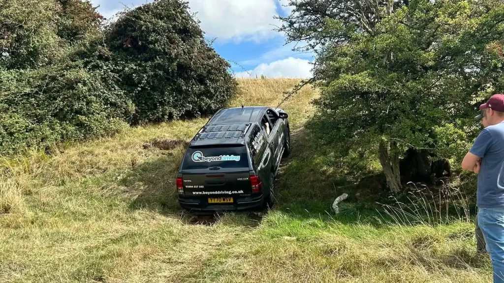 Toyota Hilux tackling steep uneven terrain during Lantra 4x4 operator training