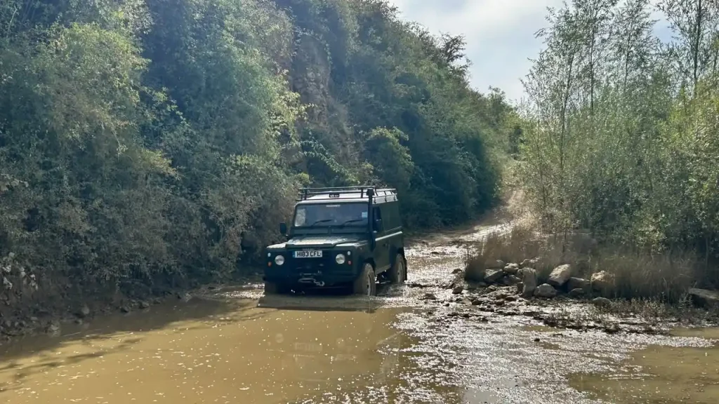 Land Rover Defender practising a water crossing during bespoke 4x4 expedition driver training