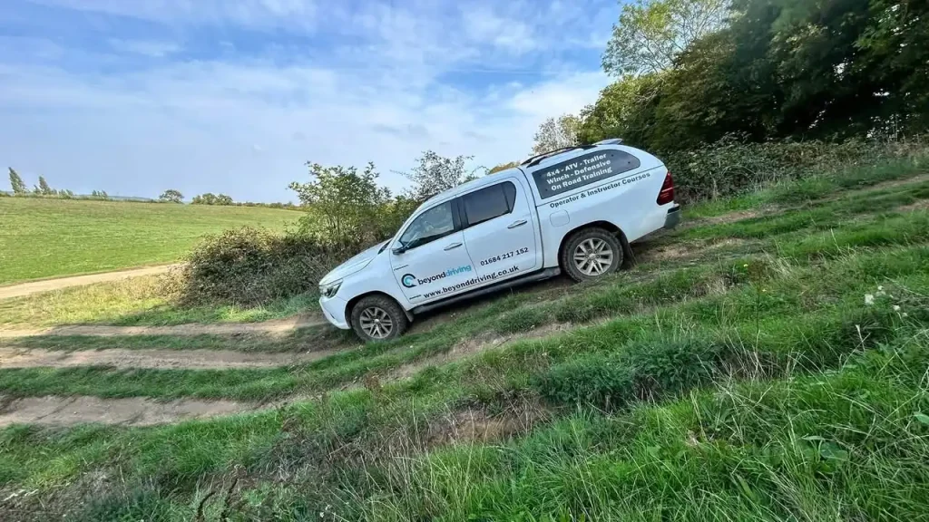 Beyond Driving Toyota Hilux tackling a steep gradient during 4x4 operator training