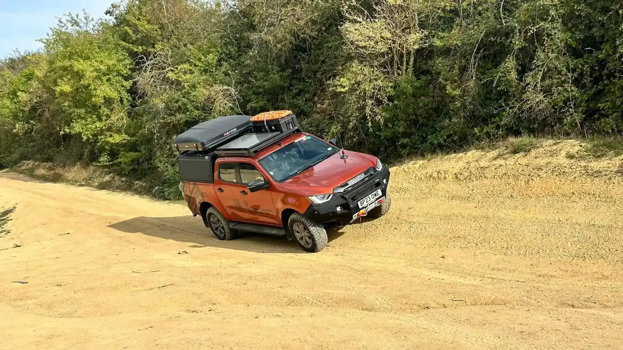 Expedition-prepared Isuzu D-Max negotiating uneven terrain during bespoke off-road training