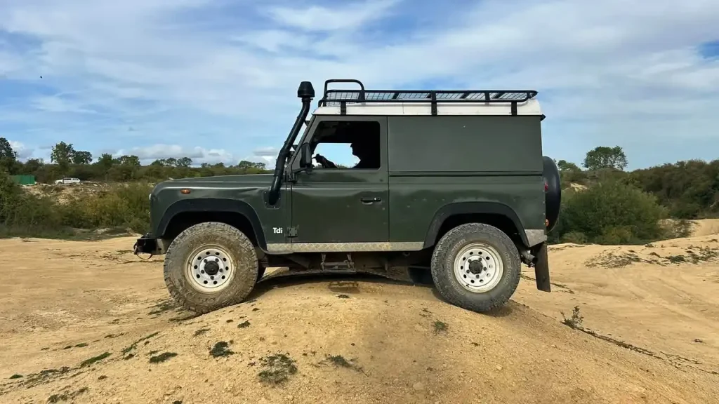 Land Rover Defender negotiating uneven ground during 4x4 expedition driver training